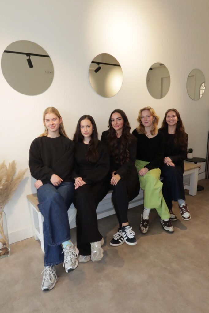 Team photo of the ALERA student project group sitting together in a modern, minimal interior.